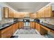 Functional kitchen with stainless steel appliances, dark countertops, and ample cabinet space at 13224 Casper Ln, Clermont, FL 34711