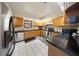 Well-lit kitchen features stainless steel appliances, granite countertops, and tile backsplash at 13224 Casper Ln, Clermont, FL 34711