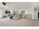 Bright living room featuring plush seating, staircase, and large windows, perfect for relaxation at 13224 Casper Ln, Clermont, FL 34711