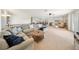 Bright, open-concept living room featuring a sectional sofa, ceiling fan, and seamless access to the dining area at 13224 Casper Ln, Clermont, FL 34711