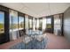 Bright sunroom featuring large windows, a glass table and chairs, and sheer curtains at 13224 Casper Ln, Clermont, FL 34711