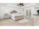 Spacious bedroom with a tray ceiling, plush carpet, and double doors leading to a private balcony at 1324 Tall Maple Loop, Oviedo, FL 32765