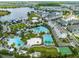 Stunning aerial view of community amenities, including multiple pools, sports courts, and recreational areas near a lake at 13800 Chauvin Ave, Orlando, FL 32827