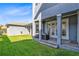 A beautiful backyard featuring a manicured lawn, covered patios with neutral furnishings, and exterior architecture at 13800 Chauvin Ave, Orlando, FL 32827