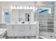 Modern bathroom featuring a large double vanity, soaking tub, and glass-enclosed shower at 13800 Chauvin Ave, Orlando, FL 32827