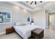 A stylish bedroom features a tray ceiling, a large bed, and warm, natural lighting at 13800 Chauvin Ave, Orlando, FL 32827