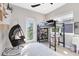 Bedroom with an elevated loft bed, a hanging chair, and plenty of natural light at 13800 Chauvin Ave, Orlando, FL 32827