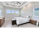 Light-filled bedroom with a tray ceiling, hardwood floors, and neutral decor at 13800 Chauvin Ave, Orlando, FL 32827