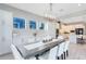 Elegant dining room with white cabinetry, a modern chandelier, and a view of the open-concept kitchen at 13800 Chauvin Ave, Orlando, FL 32827