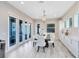 Bright dining room featuring white wood floors, a modern chandelier, and French doors to the exterior at 13800 Chauvin Ave, Orlando, FL 32827
