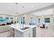 Open kitchen and living area with stainless steel appliances and modern pendant lighting at 13800 Chauvin Ave, Orlando, FL 32827