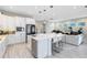 Modern kitchen with white cabinets, quartz countertops, and stainless steel appliances at 13800 Chauvin Ave, Orlando, FL 32827