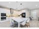 Modern kitchen with stainless steel appliances, white cabinets, and a large island at 13800 Chauvin Ave, Orlando, FL 32827