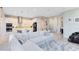 Open-concept living area with white sofa and kitchen island with barstool seating at 13800 Chauvin Ave, Orlando, FL 32827