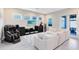 Comfortable living room featuring a plush sofa, large TV, and a massage chair at 13800 Chauvin Ave, Orlando, FL 32827