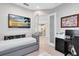 Comfortable office with a sleeper sofa and view of the modern, open-concept kitchen through French doors at 13800 Chauvin Ave, Orlando, FL 32827