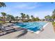 Inviting lap pool with lounge chairs surrounded by palm trees at 13800 Chauvin Ave, Orlando, FL 32827