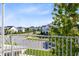 Neighborhood street view from a balcony with a manicured tree in foreground at 13800 Chauvin Ave, Orlando, FL 32827