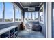 Bright sunroom showcasing a hanging chair, large windows, and stylish blue decor at 13800 Chauvin Ave, Orlando, FL 32827