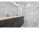 Modern bathroom featuring dual vanity sinks, white tiled shower, and soaking tub at 13809 Luna Harvest Ave, Winter Garden, FL 34787