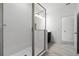 Modern bathroom featuring a frameless glass shower, white tile, and sleek fixtures at 13809 Luna Harvest Ave, Winter Garden, FL 34787