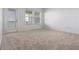 Bright bedroom with neutral carpet, natural light, and balcony access at 13809 Luna Harvest Ave, Winter Garden, FL 34787