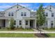 Charming townhome with light gray exterior, landscaped front yard, and covered entryway at 13809 Luna Harvest Ave, Winter Garden, FL 34787