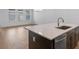 Bright kitchen island with stone countertop, stainless dishwasher, and open floorplan at 13809 Luna Harvest Ave, Winter Garden, FL 34787