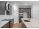 Stylish kitchen boasts dark cabinets, stainless steel appliances, and white backsplash at 13809 Luna Harvest Ave, Winter Garden, FL 34787