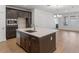 Well-appointed kitchen with island, stainless steel appliances, and dark cabinetry at 13809 Luna Harvest Ave, Winter Garden, FL 34787