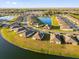 Aerial view of a community with multiple homes, manicured lawns, and a scenic lake at 1452 Hopedale Pl, Sanford, FL 32771