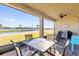Covered back porch with brick flooring and pond view. Includes ceiling fan and outdoor seating at 1452 Hopedale Pl, Sanford, FL 32771
