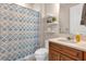 Bathroom featuring a shower with a patterned curtain, vanity, toilet, and floating shelves at 1452 Hopedale Pl, Sanford, FL 32771