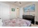 Bedroom featuring a bed, ceiling fan, dresser with TV, and a view into the hallway at 1452 Hopedale Pl, Sanford, FL 32771