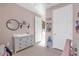 Bedroom featuring pink walls, a changing table, and natural light from the window at 1452 Hopedale Pl, Sanford, FL 32771