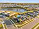 Aerial view of the community pool, clubhouse, and lake surrounded by residential homes in a neighborhood at 1452 Hopedale Pl, Sanford, FL 32771