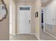 Bright entryway featuring a white door with transom window, beige walls, and tile flooring at 1452 Hopedale Pl, Sanford, FL 32771