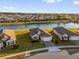 Aerial view of a single-Gathering home featuring a well-manicured lawn and a serene lake in the background at 1452 Hopedale Pl, Sanford, FL 32771