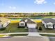 Exterior aerial view of a well-maintained single-Gathering home with a two-car garage and landscaping overlooking the lake at 1452 Hopedale Pl, Sanford, FL 32771