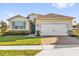 Charming single-story home with a well-manicured lawn and a brick paver driveway leading to a two-car garage at 1452 Hopedale Pl, Sanford, FL 32771
