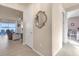Hallway featuring a decorative mirror, tile floors, and views into the living room and bedroom at 1452 Hopedale Pl, Sanford, FL 32771