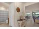 Hallway featuring an entrance to the bathroom and an opening to the living room and dining area at 1452 Hopedale Pl, Sanford, FL 32771