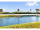 Back yard pond view separated by white fence with grassy edge at 1452 Hopedale Pl, Sanford, FL 32771