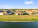 Aerial view of the backyards of several homes, all with screened-in lanais and a tranquil lake backdrop at 1452 Hopedale Pl, Sanford, FL 32771