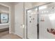 Bright shower with tile surround, glass enclosure, and built-in shower caddy at 1452 Hopedale Pl, Sanford, FL 32771