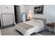 A view of the bedroom offering a bed with neutral bedding, art, and a mirror at 150 E Robinson St # 12A-15 / 1216, Orlando, FL 32801