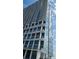 Modern high-rise condo building featuring expansive glass windows and private balconies against a blue sky at 150 E Robinson St # 12A-15 / 1216, Orlando, FL 32801