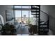 Charming living room with spiral staircase, large windows, and downtown city view at 150 E Robinson St # 12A-15 / 1216, Orlando, FL 32801