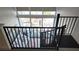 Looking down from the staircase into the living room with large windows and seating area at 150 E Robinson St # 12A-15 / 1216, Orlando, FL 32801