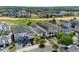 Aerial view showcases a stunning home near a golf course, with immaculate landscaping at 1543 Corolla Ct, Reunion, FL 34747